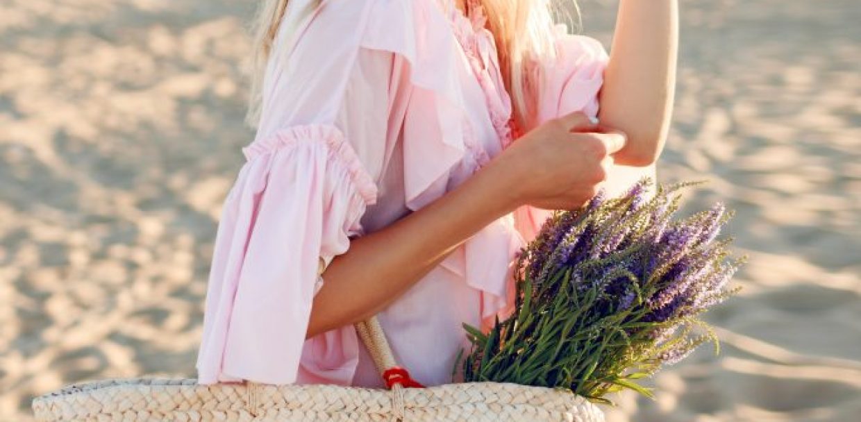 romantic-white-woman-trendy-hat-elegant-pink-dress-posing-beach-holding-straw-bag-bouquet-flowers-682x1024-1